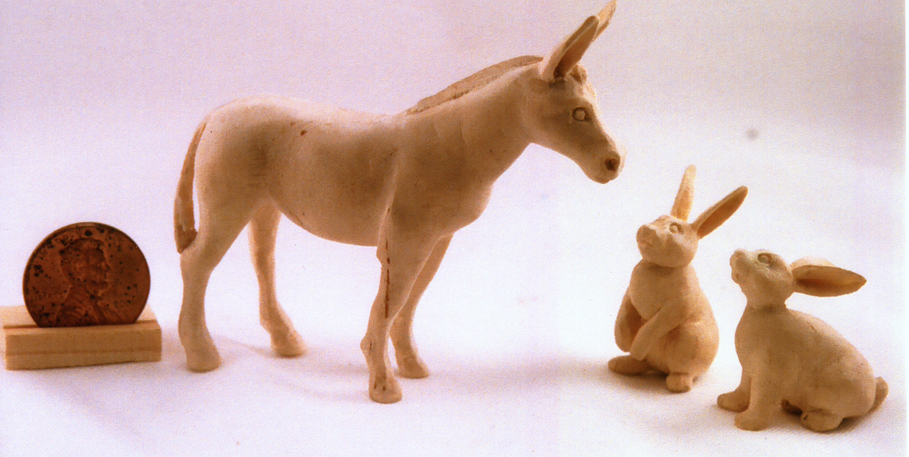 hand carved wood unpainted donkey and rabbits